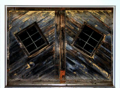 Old rustic barn door with odd windows