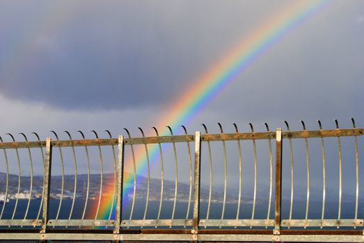 A beautiful rainbow at Tromsø bridge (Norwegian: Tromsøbrua). The Tromsø Bridge is a cantilever road bridge in the city of Tromsø, Norway. It crosses the strait of Tromsøysundet between Tromsdalen on the mainland and Tromsøya. Construction began in 1958, and the bridge was opened in 1960. At the time of its opening, it was the longest bridge in Northern Europe, with a length of 1036 meters.