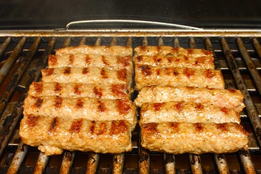 Preparing pork meat on the grill