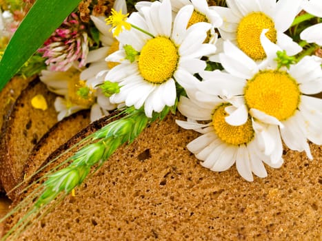 Photo of the bread with camomiles background