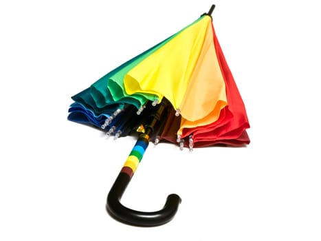 Photo of the multicolored closed umbrella against the white background
