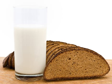 Photo of the bread and milk at wooden broad against the white background  