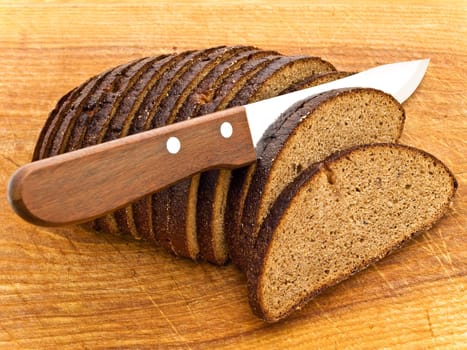 Photo of background the slice bread and  knife at wooden broad