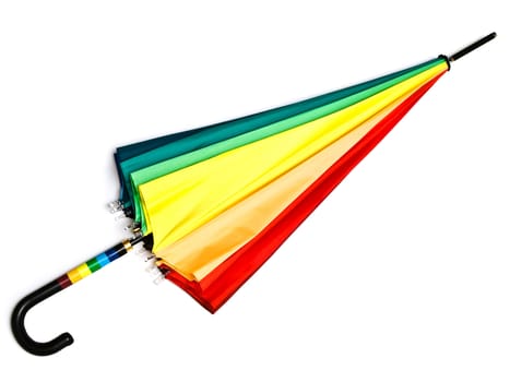Photo of the multicolored closed umbrella against the white background