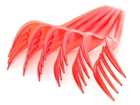 Photo of the red plastic forks against the white background