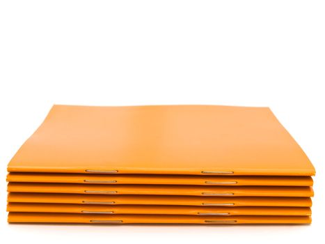 photo of the some orange booklets against the white background