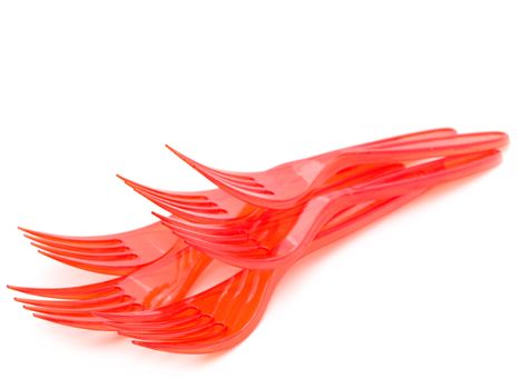 Photo of the red plastic forks against the white background
