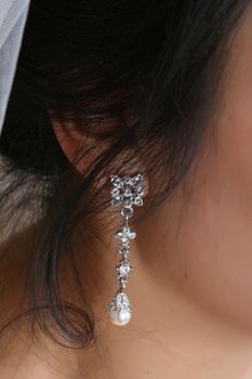 Diamond and silver earring worn by a bride