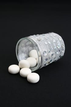 Decorated glass wih mints on a black background