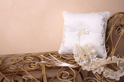 Ring Pillow and garter on an old style rustic seat