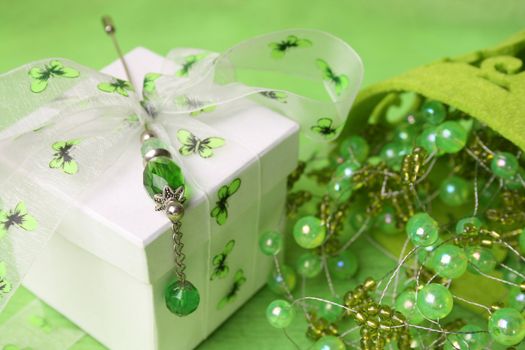 White gift box with ribbon and beaded decorations