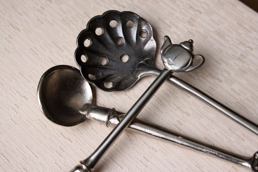 Silver spoons on a cream coloured box background
