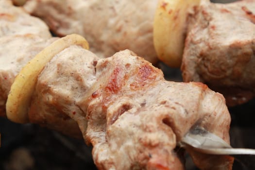 Shish kebab - shashlik - caucasian kitchen. Meat on skewers fried on coals.