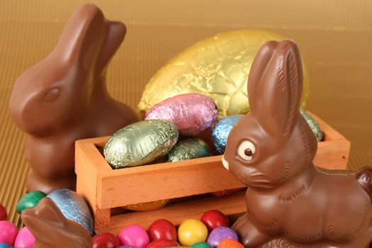 Various colors and shaped easter eggs and chocolate bunnies