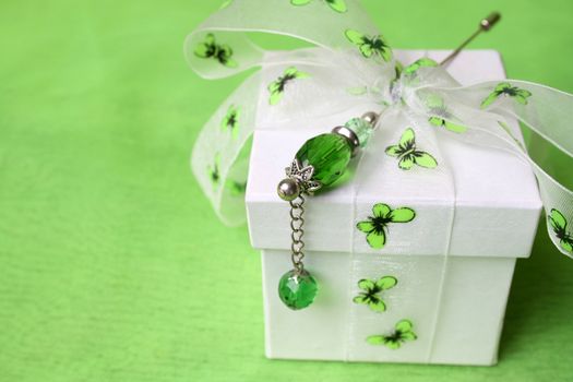 White gift box with butterfly ribbon and pin