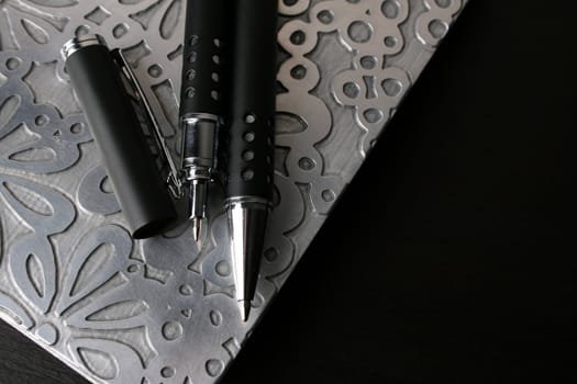 Fancy pen on a small file with white pages