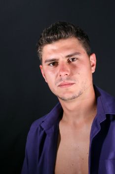 Male model in studio against a dark wall