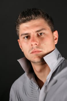 Male model in studio against black background