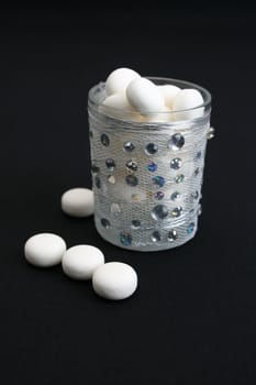 Decorated glass wih mints on a black background