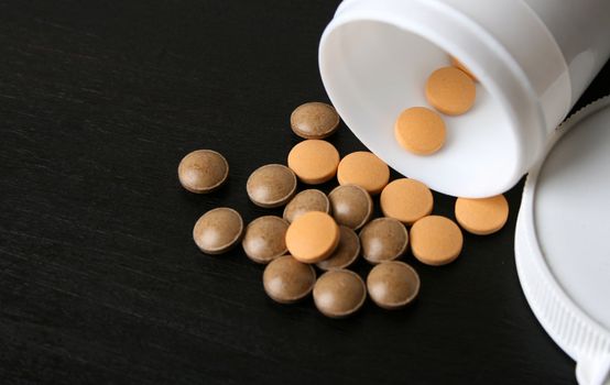 Pills falling from a bottle. FOCUS on pills in bottle
