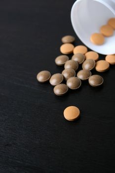 Pills falling from a bottle. FOCUS on pills in bottle
