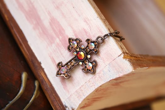 Copper Cross haning from a wooden jewellery box