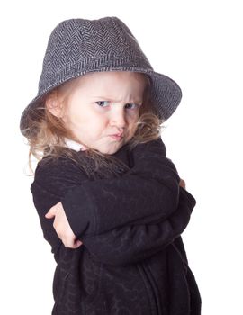 An isolation on white of an adorable child.  Her arms are crossed.