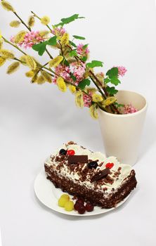 delicious cake with cherry and grape and bouquet of flowers