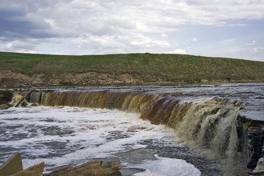 Waterfall in cloudy spring day