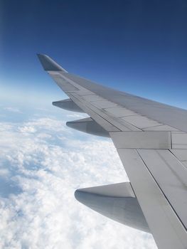 wing of an airplane above the sky