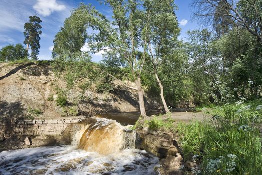 Boisterous waterfall of a small river