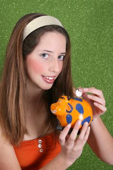 Brunette teenager on a green background wearing a broad head band