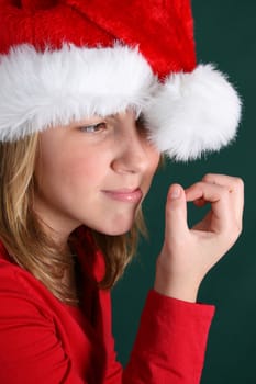 Teenager in red shirt and fluffy christmas hat