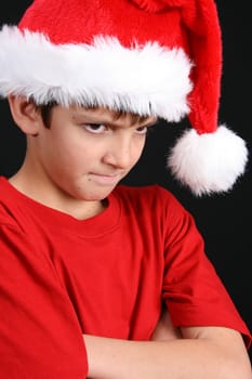 Young boy wearing a red shirt and christmas hat