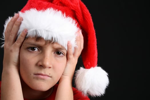 Young boy wearing a red shirt and christmas hat
