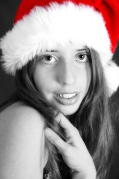 Brunette Teenager wearing a fluffy christmas hat
