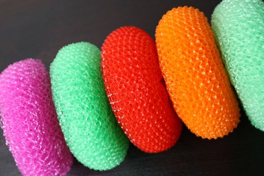 Various colors of dish washing scrunchies on a heap