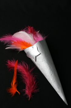 Brightly colored feather confetti in a cone