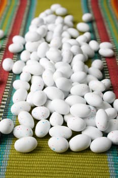 Miniature speckled easter eggs on a green place-mat