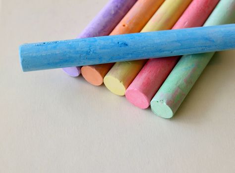 Blackboard chalk in various colors on a cream colored surface