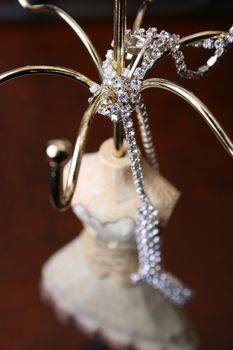 Diamond Necklace draped over a wooden jewelery stand
