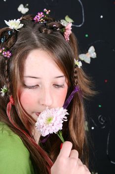 Teenage model with flowers and butterflies in her hair