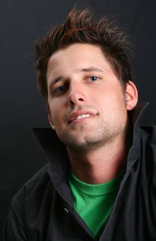Male model in studio against black background