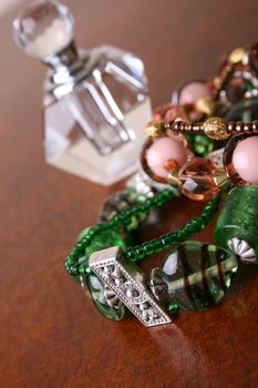 Green and Orange beaded jewelery with perfume bottle
