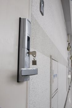 a modern door lock with a key and with door camera.