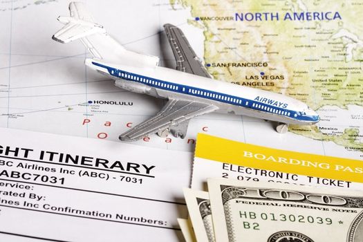 Flight itinerary to usa with toy airplane and map of usa.