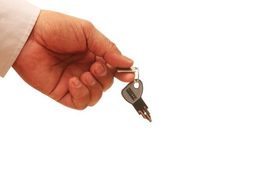 close up of a person's hand handing over the key over white background.