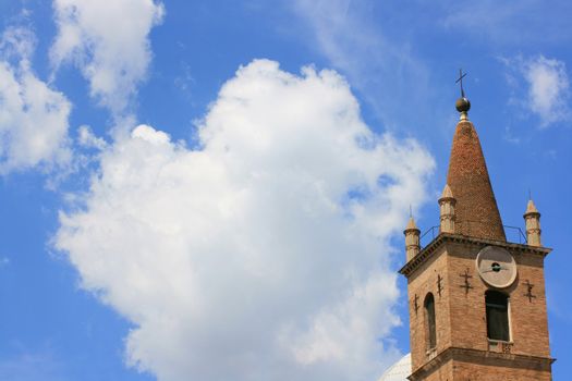 Piazza del popolo, Rome Italy. Church set against a blue sky with crisp white clouds.