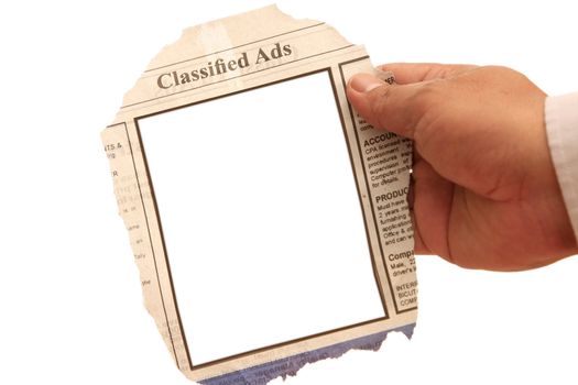 Hand holding a classified ads- many uses in the employment and resources.