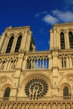 Notre Dame Cathedral, Paris France. Set on a deep blue sky at sunset.